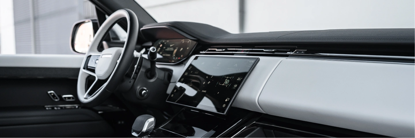 White leather interior of Range Rover Sport with panoramic roof and spacious front seats.