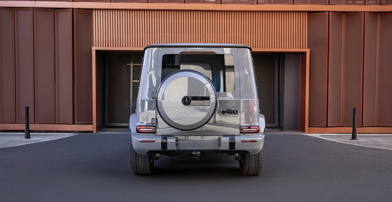 Rear view of the Mercedes-AMG G 63 featuring a signature spare wheel cover and distinctive LED taillights.