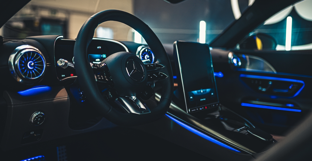 Mercedes SL55 AMG interior — illuminated vents, digital cluster, and vertical infotainment screen